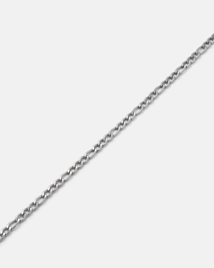 The 2.9mm Figaro Chain, featuring small, oval links and a non-tarnish finish, is displayed diagonally on a plain white background.