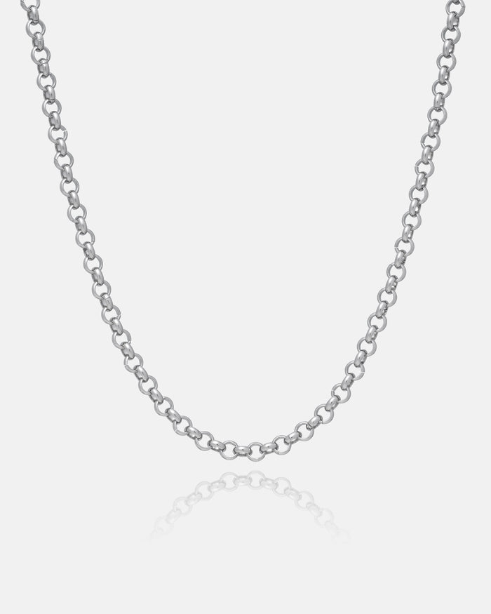 A close-up of the 5mm Rolo Chain, a non-tarnish stainless steel necklace with round links, displayed on a plain white background. The necklace curves gently, with a subtle reflection visible below.