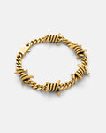 Gold 6mm barbed wire bracelet by statement collective on grey background.