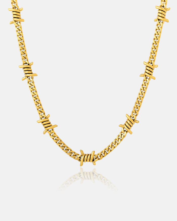 The 6mm Barbed Wire Cuban Chain (Gold) features a gold-plated Cuban link design with evenly spaced barbed wire-inspired accents, shown on a plain white background.