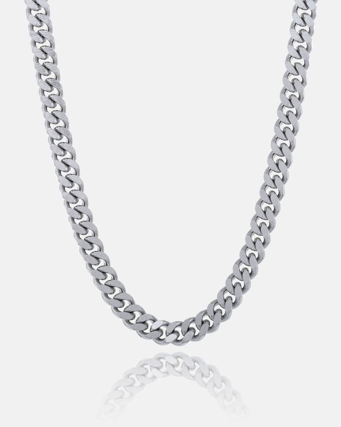 The 6mm Cuban Chain, made from stainless steel, is shown against a white background with its reflection below. This non-tarnish necklace offers lasting shine and durability.