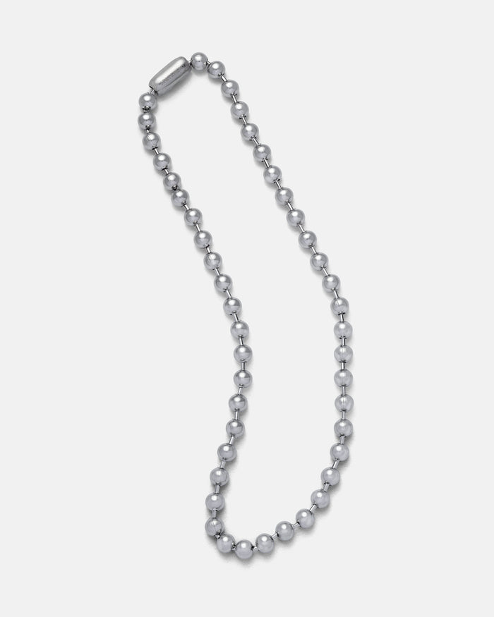 The 7mm Ball Chain is a stainless steel necklace with evenly spaced round beads and a cylindrical clasp, shown in an oval on a white background—ideal for vintage punk style or as a 90s mall goth accessory.