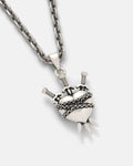 The 925 Sterling Silver "3 of Swords" Pendant features a heart wrapped in barbed wire and pierced by three swords, hanging from a thick chain and displayed against a plain light background.