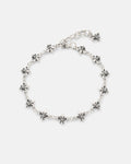 The Statement Collective 925 Sterling Silver "Fleur De Lis" 10mm Bracelet showcases a chain of small, evenly spaced fleur-de-lis charms and features an adjustable clasp, beautifully presented on a plain white background.