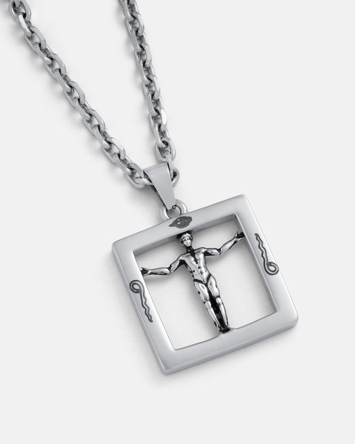 Agrippa’s Square Pendant is a silver chain necklace featuring a square pendant with a raised, stylized man with outstretched arms and decorative corner details, inspired by occult jewelry.