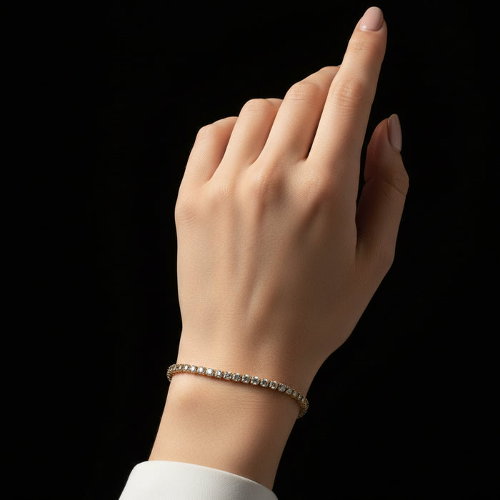 Gold bracelet with clear stones on a black background