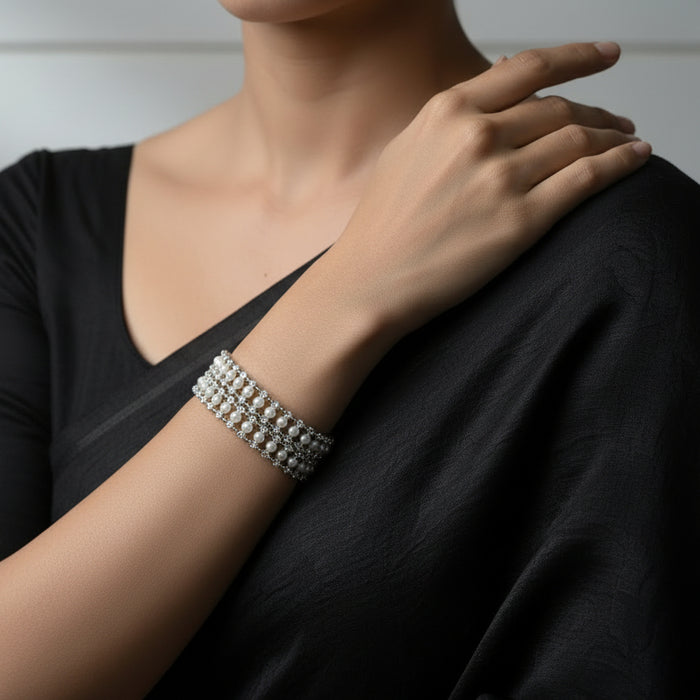 Pearl bracelet on a dark background with 'SAHELI' branding.