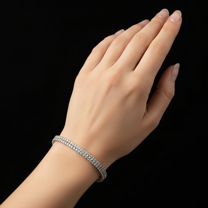 Silver bracelet with clear stones on a black background