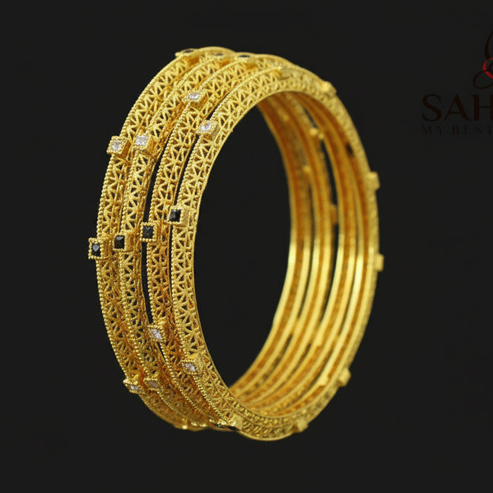 Gold bangles on a dark background with 'Saheli' brand logo.