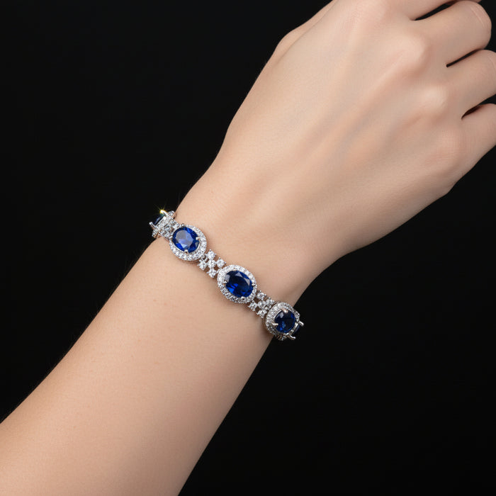 Jewelry necklace with blue stones on a black background, featuring the brand 'Saheli'.