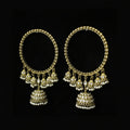 Pair of gold hoop earrings with dangling beads on a black background