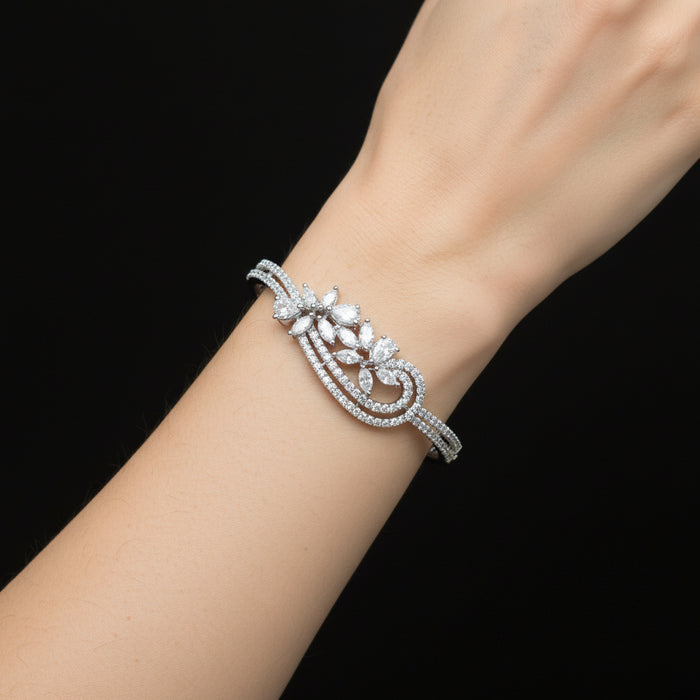 Silver bracelet with diamond-like stones on a gray surface