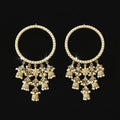 Pair of gold chokers with floral pendants on a black background