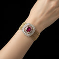 Jewelry box with a decorative headband featuring a red gemstone and gold band on a gray cushion, branded 'Saheli'.
