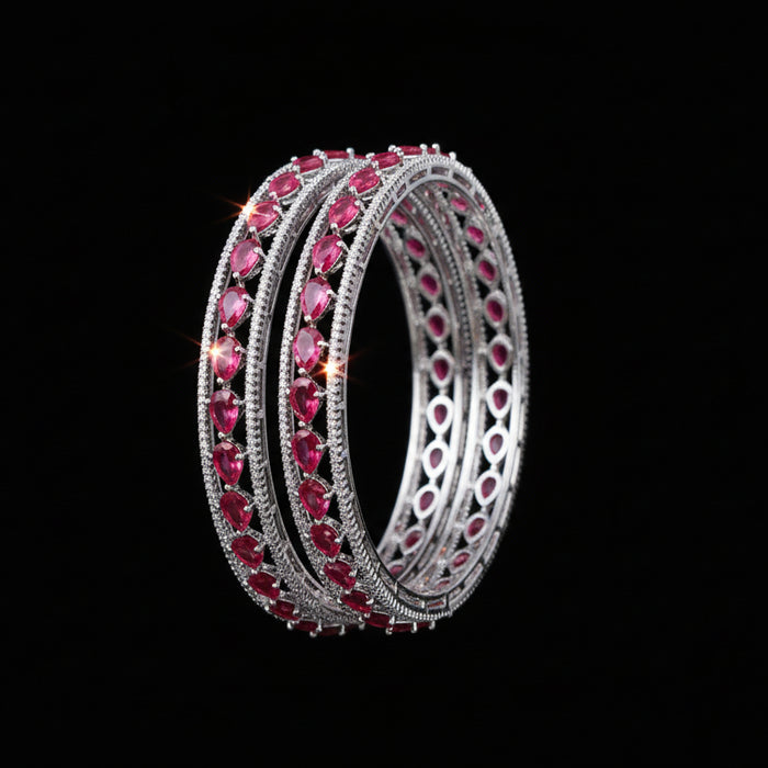 Pair of pink gemstone hoop earrings on a black background with 'SAHELI' brand logo.