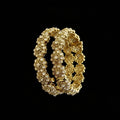 Gold bracelet with pearls on a gray background, featuring the brand 'SAHELLI'.