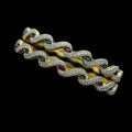 Gold chain bracelet on a black stand with 'SAHELI' branding.