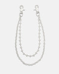 Introducing the “Baroque” Fleur De Lis Wallet Chain by Statement Collective: this set features two sterling silver chains, each fitted with clasp hooks at both ends and designed with star-shaped links accented by delicate fleur de lis motifs. The chains come in slightly different lengths to create a layered effect, beautifully displayed against a plain white background.
