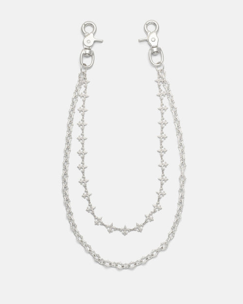 Introducing the “Baroque” Fleur De Lis Wallet Chain by Statement Collective: this set features two sterling silver chains, each fitted with clasp hooks at both ends and designed with star-shaped links accented by delicate fleur de lis motifs. The chains come in slightly different lengths to create a layered effect, beautifully displayed against a plain white background.
