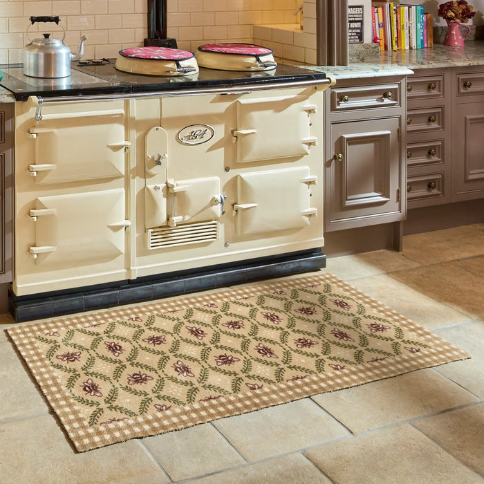 Beehive Beige Charity Runner- 100% recycled cotton runner featuring a collection of bees surrounded by green laurel branches in an oval pattern.