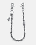 The "Boneyards" Skull Wallet Chain is a silver stainless steel accessory with two lobster clasps, small skull details along the chain, and a dangling skull charm near one clasp, shown on a plain light background.