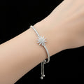 Silver bracelet with star-shaped clasp on a dark background, branded 'SAHELI'.