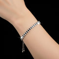 Silver bracelet on a dark gray background