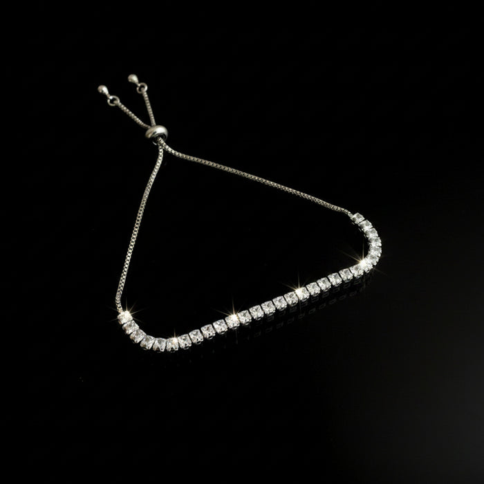 Silver beaded bracelet on a black background