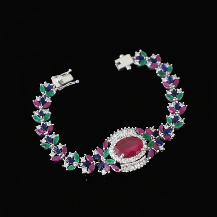 Colorful gemstone bracelet with silver accents on a black background, featuring the brand 'Saheli'.