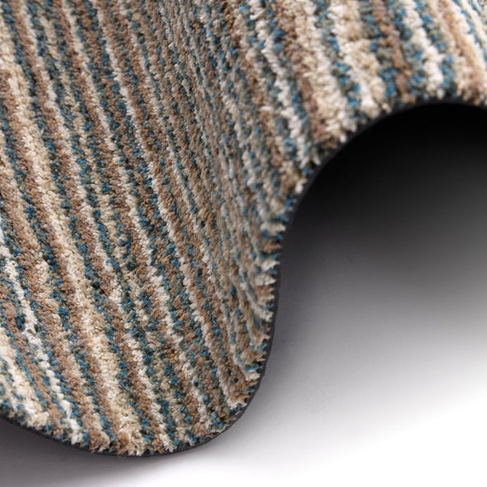 Candy Sand Striped Washable Runner- a 100% recycled material runner featuring a subtle striped pattern in shades of teal, beige, brown, white, and light grey.