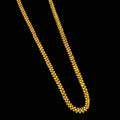 Gold necklace on a gray background with 'SAHELI' branding.
