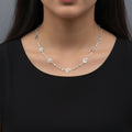 Silver necklace on a black mannequin with 'SAHELI' branding.