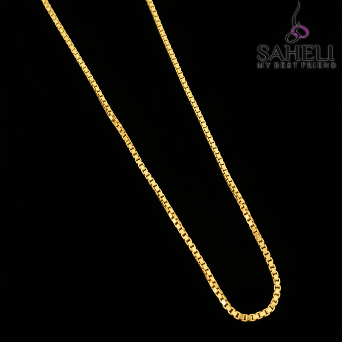 Gold chain necklace on a gray background with 'SAHELI' branding.