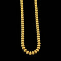 Gold chain necklace on a gray background with 'SAHELI' branding.