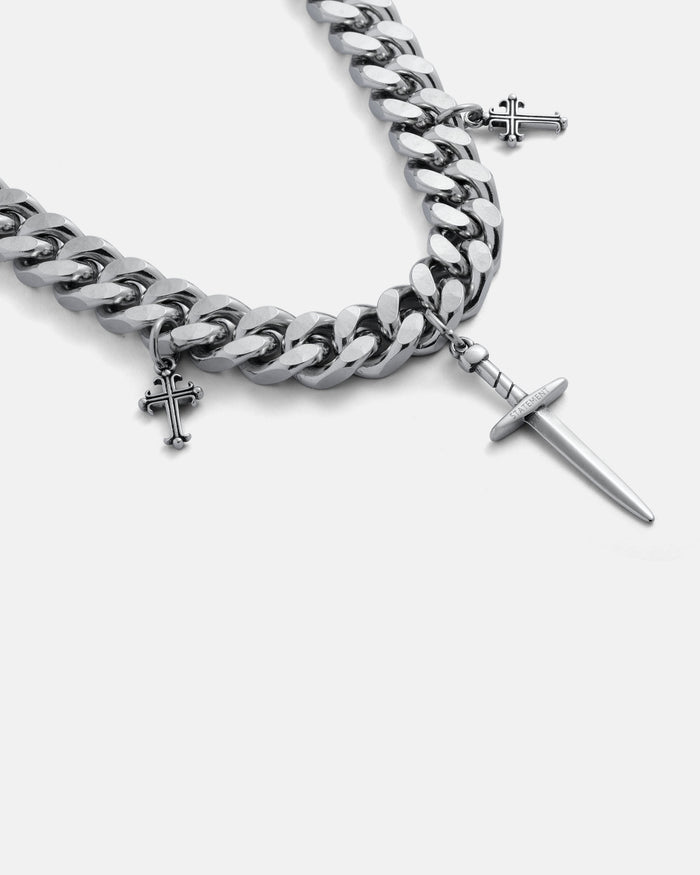 Silver chain bracelet with cross charms on a grey background