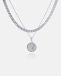 The Cuban Set (Custom Pendant Choice) includes three layered silver necklaces: a thick Cuban link chain, a thin chain, and a thin chain with your choice of engraved round pendant, all displayed on a white background.