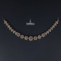 Delicate silver necklace on a dark background with 'SAHELI' branding.