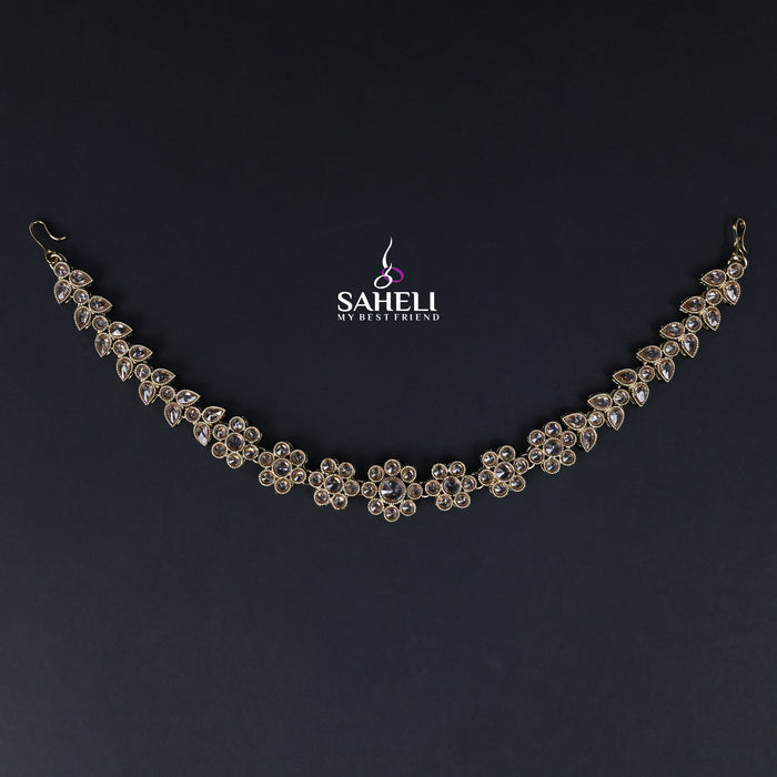 Delicate silver necklace on a dark background with 'SAHELI' branding.