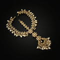 Ornate necklace with floral design on a dark background, featuring the brand 'Saheli'.