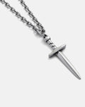 The Dagger Pendant is a silver chain necklace with an engraved "STATEMENT" hilt, shown on a light gray background—ideal for fans of hand-carved jewelry.