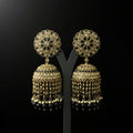 Gold and black earrings on a black background