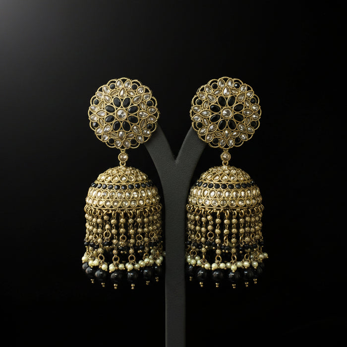 Gold and black earrings on a black background