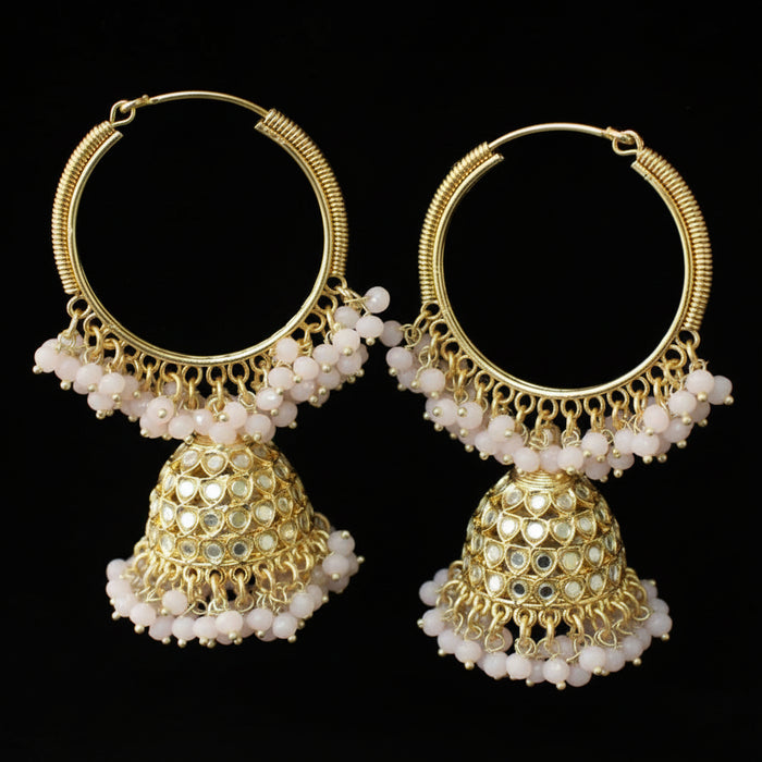 Pair of gold hoop earrings with white beads on a black background