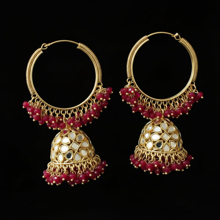 Gold and red beaded earrings on a black background