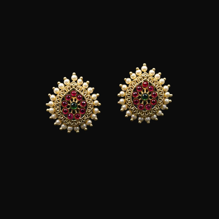 Decorative earrings with gemstones on a black background, featuring the 'Saheli' brand.