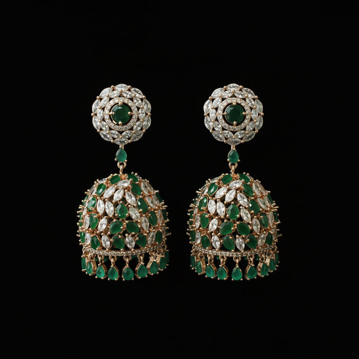 Pair of emerald and diamond earrings on a black stand