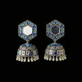 Ornate silver earrings with blue and green gemstones on a black background