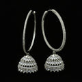 Silver hoop earrings on a black stand with 'Saheli' branding.