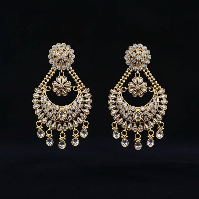 A pair of gold-toned Indian chandelier earrings adorned with clear crystals, displayed on a black background with the brand logo 'SAHELL MY BEST FRIEND' above them.