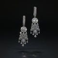 Pair of silver chandelier earrings on a dark background